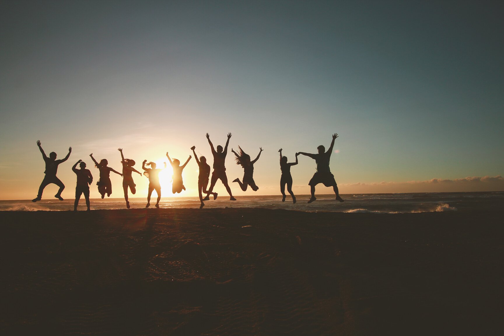 Silhouette Photography of Group of People Jumping during Golden Time